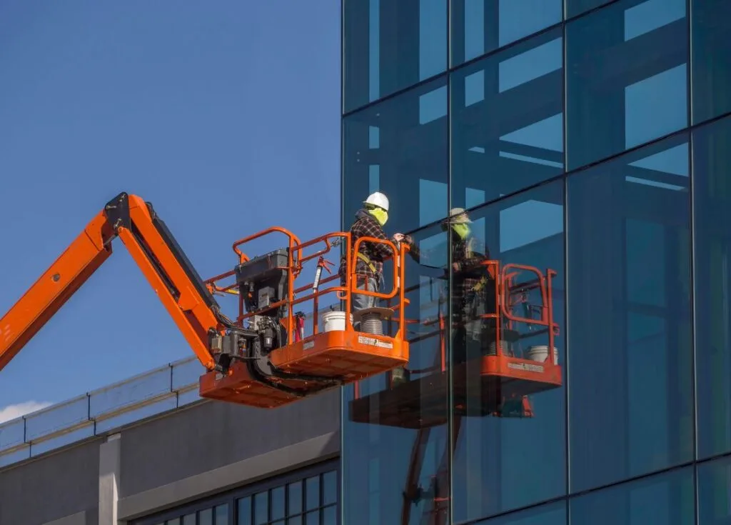 Man on crane for commercial window replacement in Auburn, WA