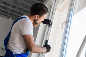 Contractor performing a commercial window replacement for a business in Seattle, WA